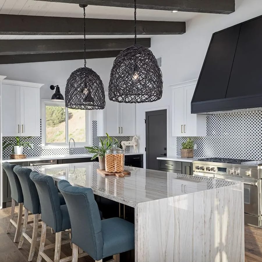 Custom kitchen remodel with waterfall marble island and vaulted beam ceiling
